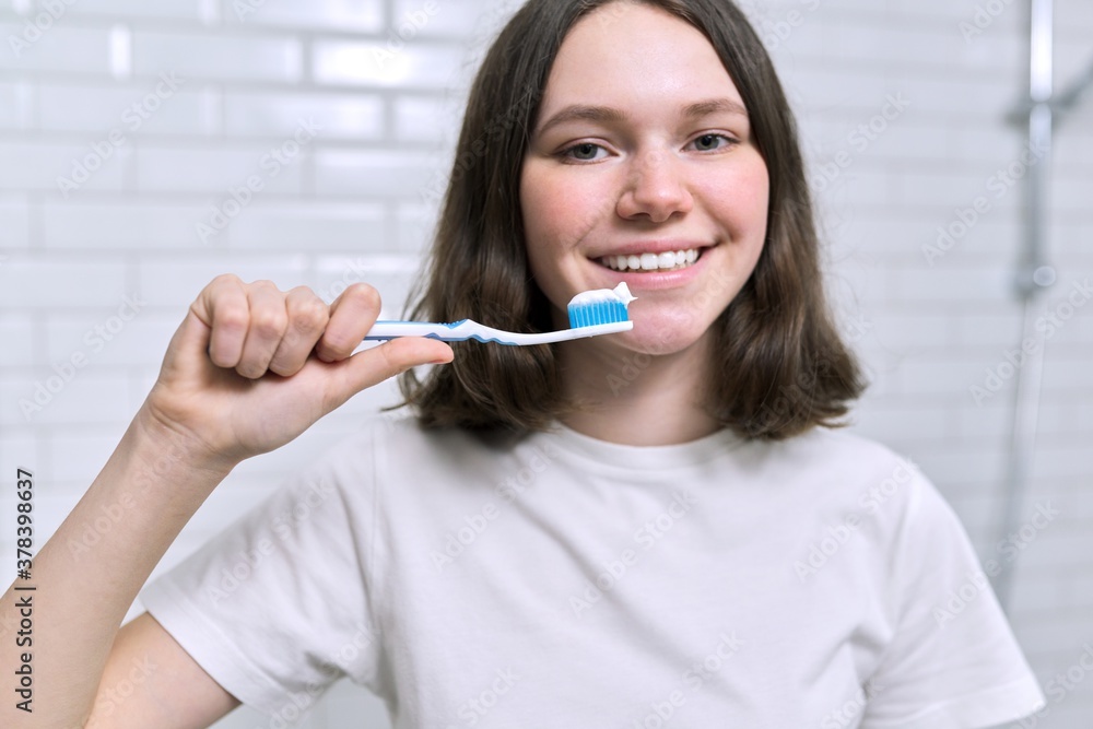 Close-up of teenager girl with toothpaste on brush Close-up of teenager girl with toothpaste on brush