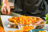 cropped shot of chef chopping ingredients for pumpkin soup