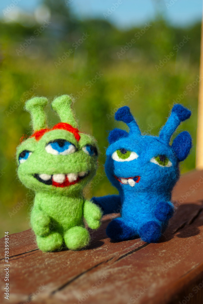 Two felted toy monsters