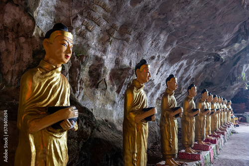 Myanmar, Kayin State, Hpa-an, Row of Buddha statues inside Saddan Cave photo