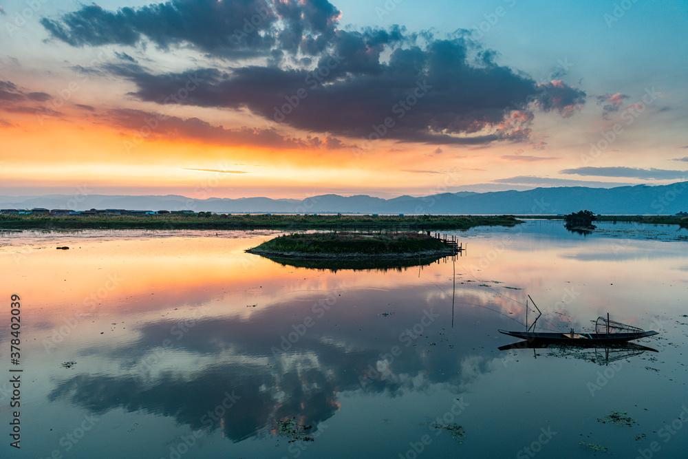 Myanmar, Shan state, Nampan, Traditional rowing boat on Inle lake at sunset Myanmar, Shan state, Nampan, Traditional rowing boat on Inle lake at sunset