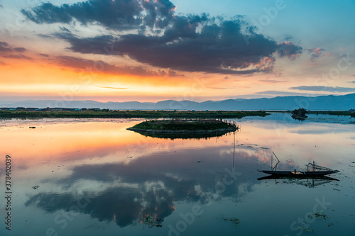 Myanmar, Shan state, Nampan, Traditional rowing boat on Inle lake at sunset photo