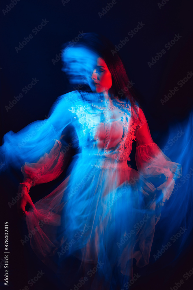 blurry portrait of a young girl with mental disorders in a dress on a dark background