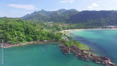 Tropical Koh Chang island dense mountain woodland idyllic turquoise bay coastline aerial view descending