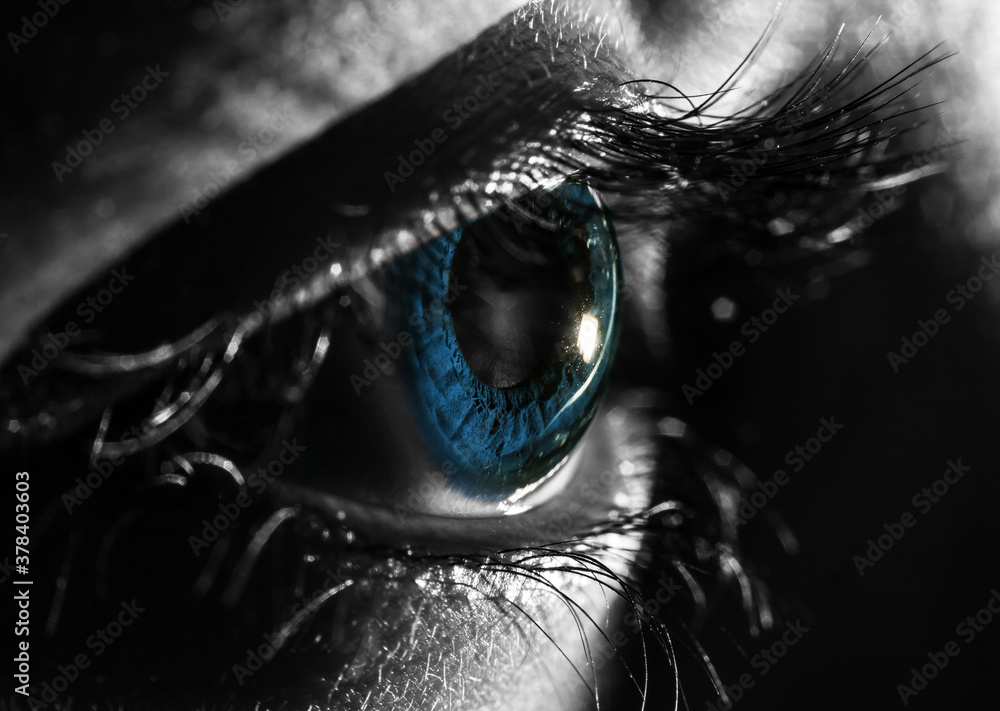 macro photo of close up shot of blue eye. black and white selective  coloration Stock Photo