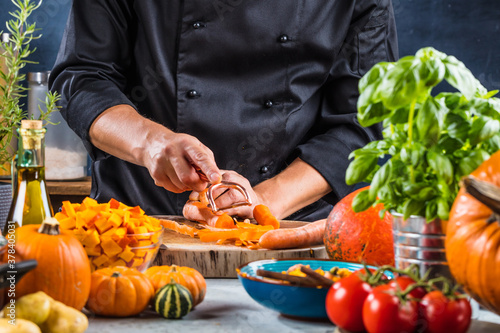 cropped shot of chef chopping ingredients for pumpkin soup