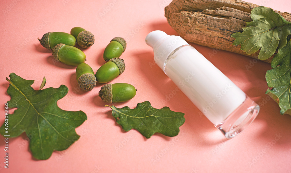 Cosmetic bottle container with green acorns, oak leaves and wood. Natural beauty product concept. Skin care, organic cosmetics, vegan cosmetics. Copy space. Acorn natural cosmetics. Cosmetic bottle container with green acorns, oak leaves and wood. Natural beauty product concept. Skin care, organic cosmetics, vegan cosmetics. Copy space. Acorn natural cosmetics.