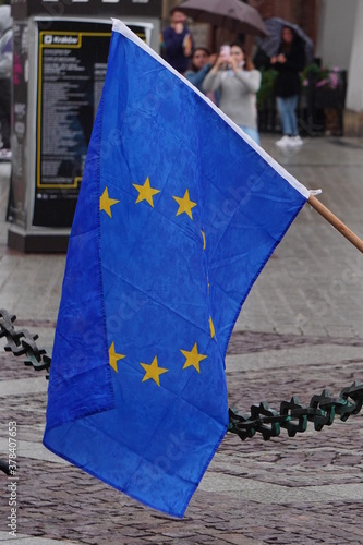 The flag of European Union is blue with stars and flag of Poland is red with white. Hanging flags on balconies of apartment buildings for public holidays. May 2, November 11, independence or labor