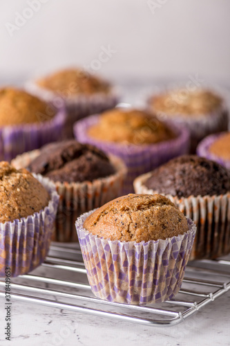 Sweet cakes or cupcakes on light marble background. Holiday cake celebration, delicious dessert, close up