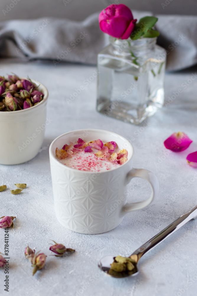 Pink moon milk with rose petals, healthy ayurvedic drink in mug Pink moon milk with rose petals, healthy ayurvedic drink in mug