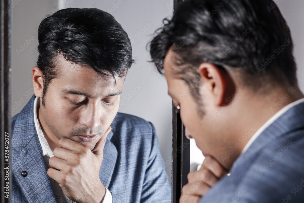asian man in suit looking after his appearance in front of a mirror beauty styling lifestyle. asian man in suit looking after his appearance in front of a mirror beauty styling lifestyle.