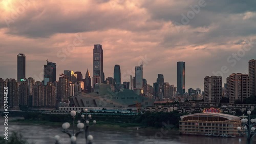 Tall buildings stand and flourish city setting sun