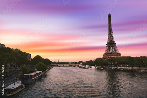 Sunset over the the Eiffel Tower and the Seine River in Paris, France. © Jbyard