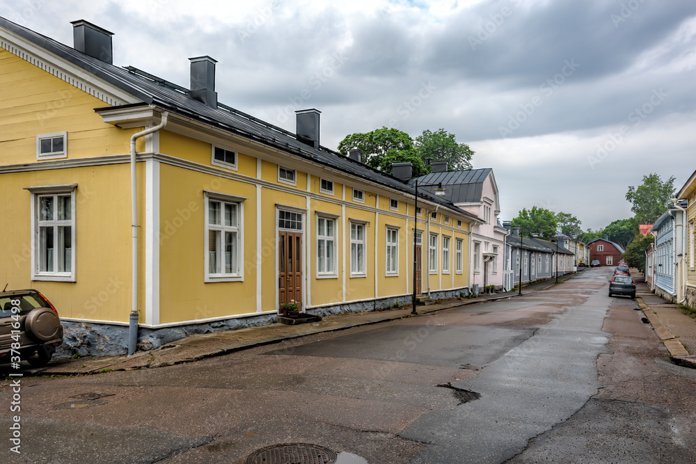 Narrow wet street with ancient houses in small coastal town Tammisaari (Ekenas), Finland, after rainstorm