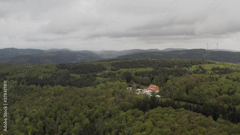 Aerial view on remote country house surrounded by dense forest in germany Aerial view on remote country house surrounded by dense forest in germany