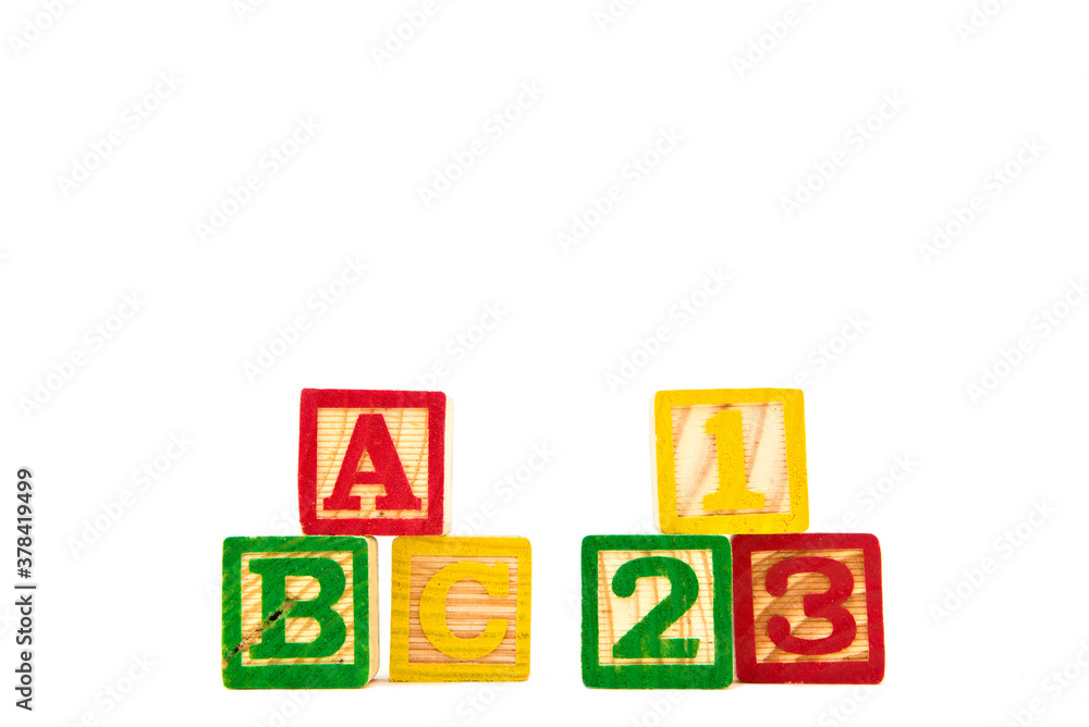 Colored letter cubes made from wood spelling ABC and 123 to illustrate the concept of learning. Isolated on white. Colored letter cubes made from wood spelling ABC and 123 to illustrate the concept of learning. Isolated on white.