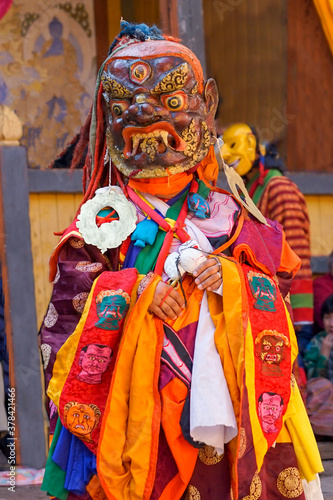 Bumthang in Bhutan at the yearly festival in the monastery of Jakar. A monk is wearing a colourful traditional mask.