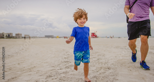 Obraz na plátne Boy playing on the beach at siesta Key florida with the snd and birds
