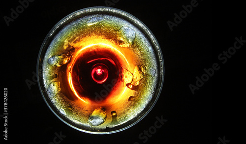 iced cold drink in a glass view from top isolated in black background