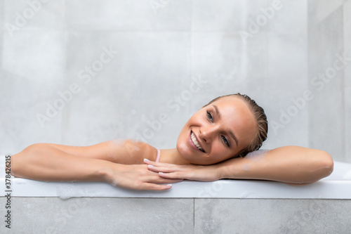 Portrait of a young woman relaxing in the bathtube