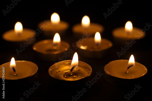 Burning candles. Many Christmas candles are burning in the dark. Selective focus, candles out of focus.