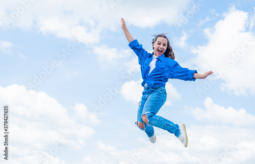 cheerful teen girl jumping high. kid jump outdoor. kid fashion and beauty. sense of freedom. portrait of energetic child girl. concept of future. happy childhood. Feeling free and happy
