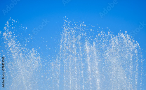 artesian fountain on blue sky photo