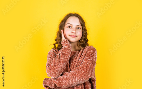 Enjoy silky hair. Beautiful little model. Healthy curls. Easy hairdo. Hairdresser salon. Pretty girl curly hair yellow background. Adorable small child. Beauty supplies. Perfectly untangle curly hair