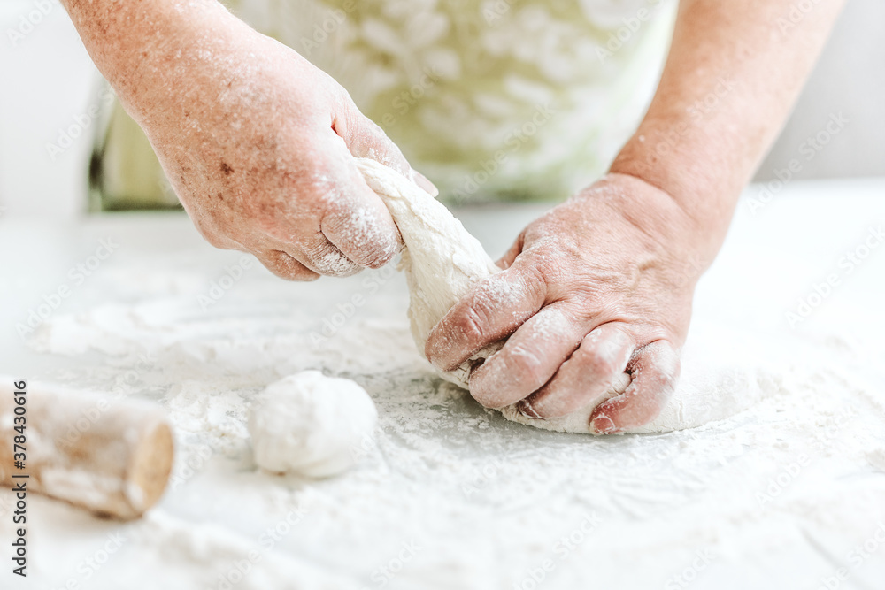 Woman kneading dough at home kitchen