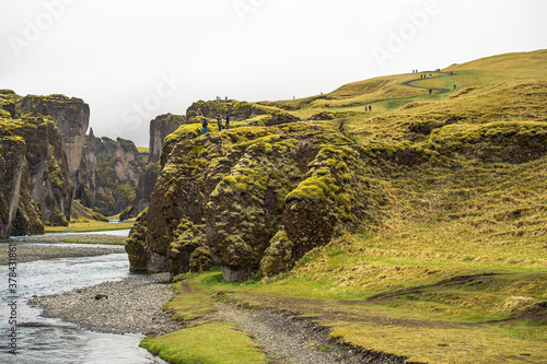 People walking in the Fjaðrárgljúfur canyon, Iceland. photo