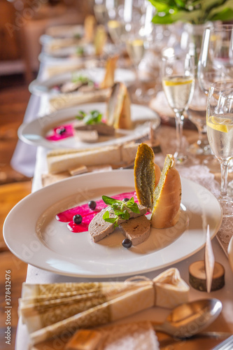 Wedding feast table with a foie gras as an appetizer served