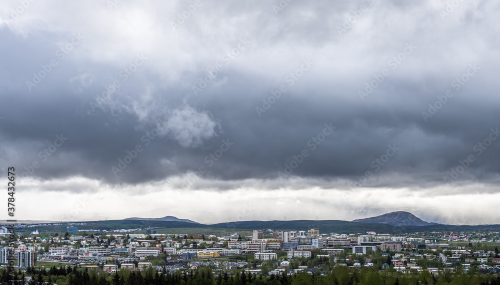 REYKJAVIK / ICELAND - MAY 26 2017: Dramatic cityscape of Reykjavik, Iceland, with dark clouds in the background.