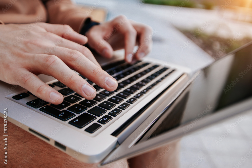 male hands are typing text on laptop keyboard male hands are typing text on laptop keyboard