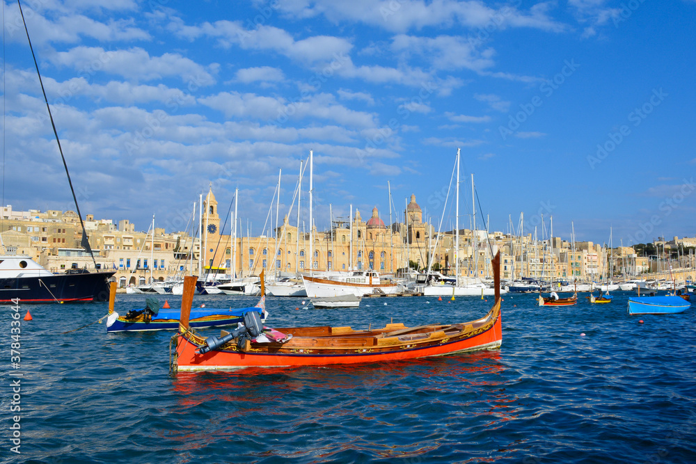 Red maltese boat in port