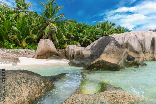 Beautiful tropical beach Anse Source dÂ´Argent with sculpted granite rocks and palm trees. Seychelles is the most beautiful tropical islands of the world's in the Indian Ocean.