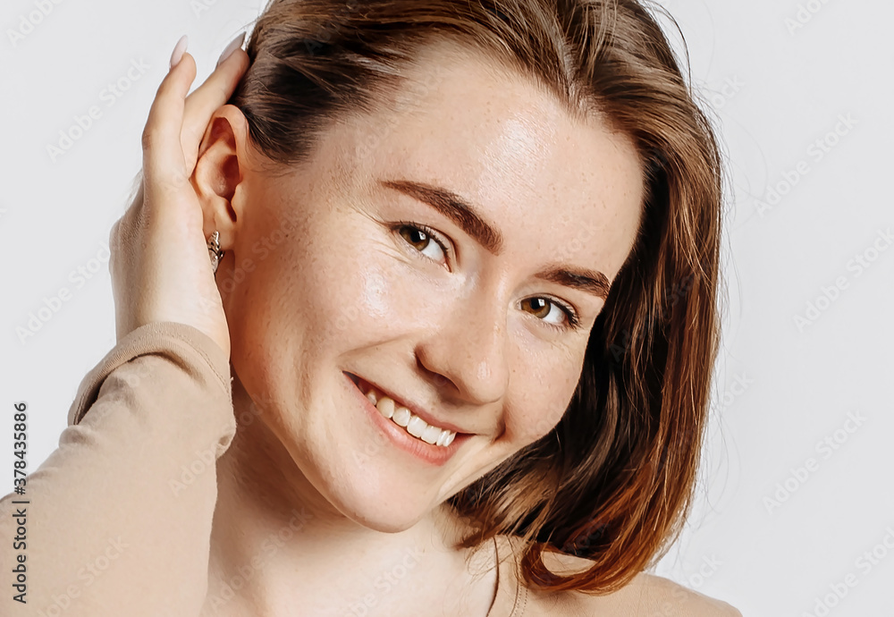 Beautiful young girl smiling and posing looking at the camera on a white isolated background. Positive brunette woman. Kind look. Beauty face. Beautiful young girl smiling and posing looking at the camera on a white isolated background. Positive brunette woman. Kind look. Beauty face.