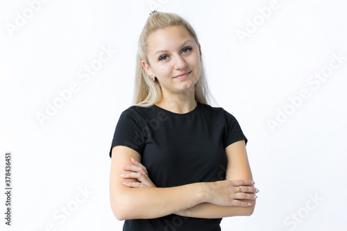 portrait of a girl with fair hair, looking with satisfaction at camera, being happy. Beautiful woman isolated against blank studio wall.