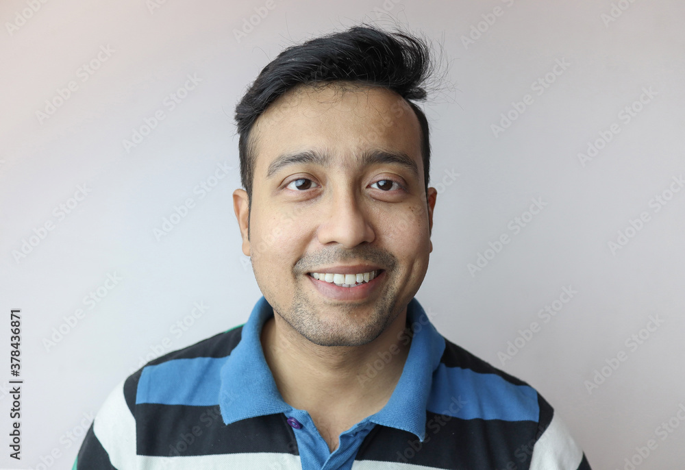 a young indian man confident and smiling isolated in white background with copy space for text a young indian man confident and smiling isolated in white background with copy space for text