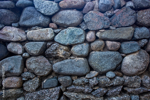 Stone wall texture, big and small rocks forming a wall