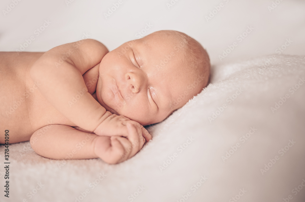 Cute emotional newborn funny little baby boy sleeping in crib. Baby goods packaging template. Healthy child, concept of hospital and happy motherhood. Infant baby. Nursery Cute emotional newborn funny little baby boy sleeping in crib. Baby goods packaging template. Healthy child, concept of hospital and happy motherhood. Infant baby. Nursery