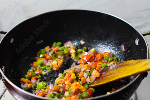 finely chopped vegetables fried in oil in a frying pan closeup view