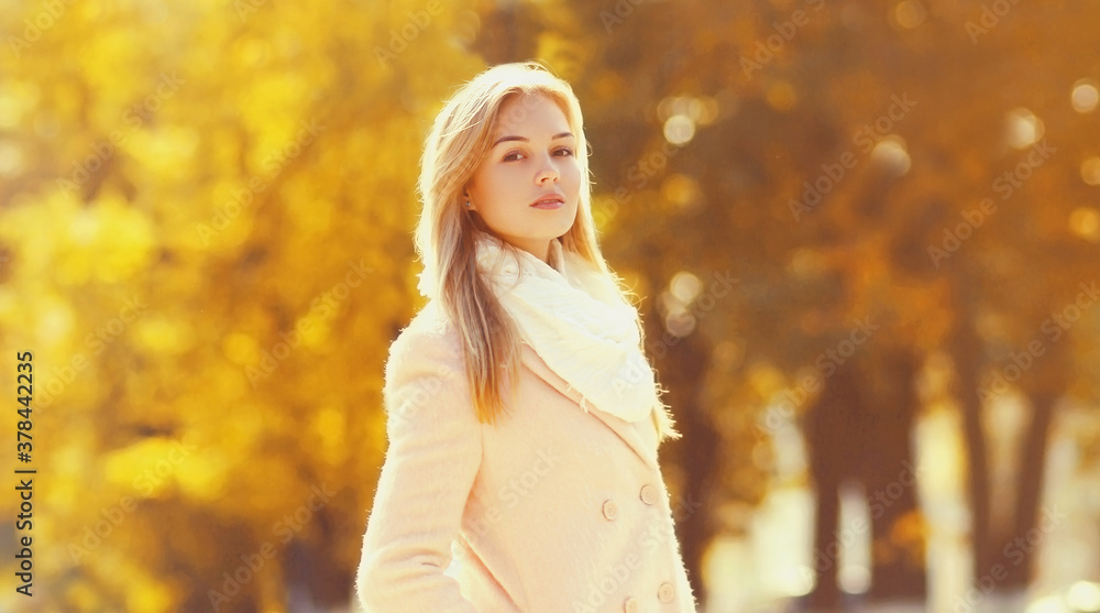 Portrait of beautiful young blonde woman in sunny autumn park Portrait of beautiful young blonde woman in sunny autumn park