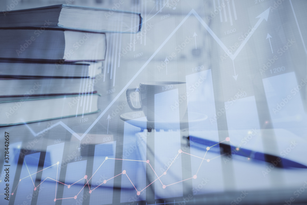 Double exposure of financial chart drawing and desktop with coffee and items on table background. Concept of forex market trading Double exposure of financial chart drawing and desktop with coffee and items on table background. Concept of forex market trading