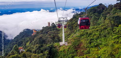 cable car at genting highlands, malaysia in a foggy weather with green grass visible from inside cable car photo