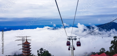 cable car at genting highlands, malaysia in a foggy weather with green grass visible from inside cable car