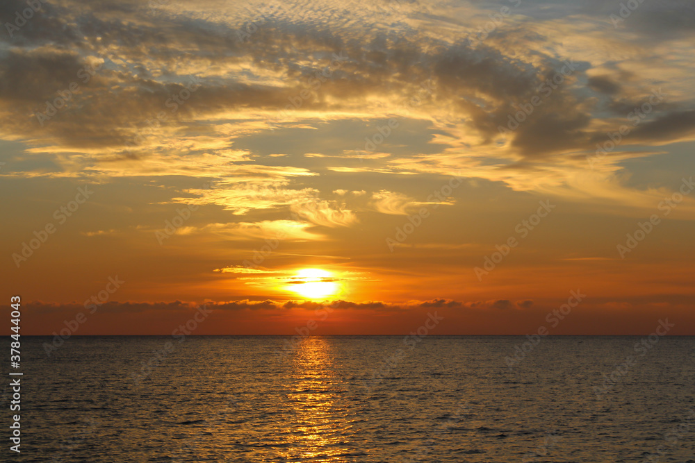 Photo of the beautiful 
 a warm sunset on the sea.