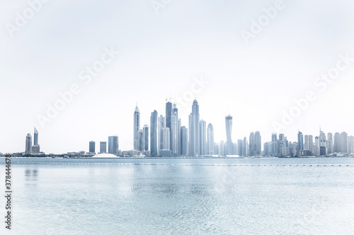 Skyscrapers on the coast and ocean with a bleached effect