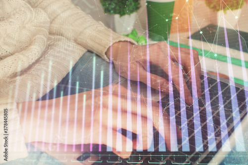 Double exposure of woman hands typing on computer and forex chart hologram drawing. Stock market invest concept.