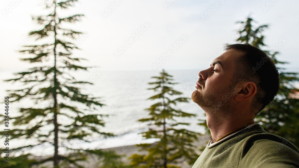 Caucasian man enjoys the sound of the surf on the balcony of the hotel or residential house. Caucasian man enjoys the sound of the surf on the balcony of the hotel or residential house.