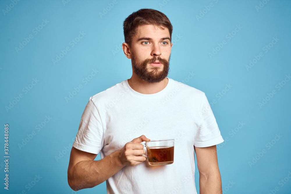 Man with a cup of tea on blue background cropped view of fun emotion Copy Space Man with a cup of tea on blue background cropped view of fun emotion Copy Space